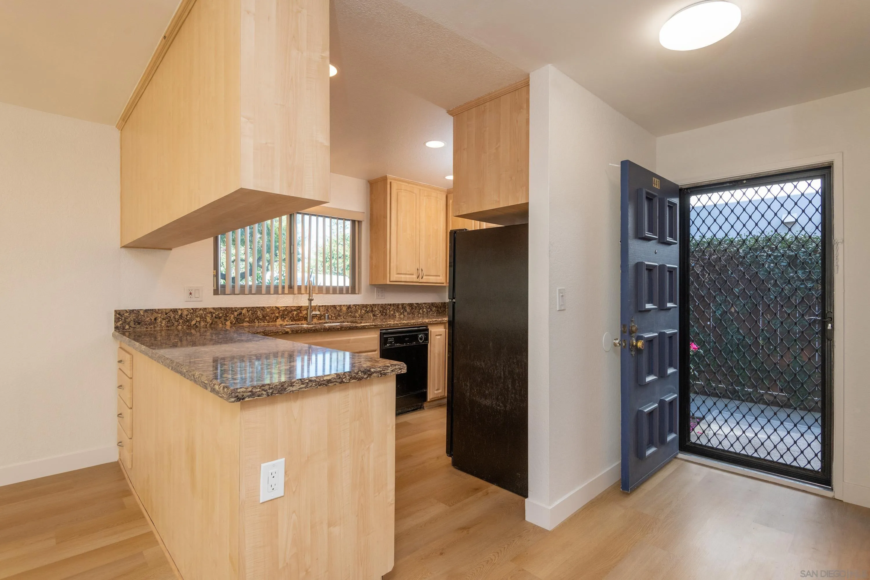 441 D Avenue Coronado, CA 92118 - Photo 3 of 24 a kitchen with stainless steel appliances granite countertop a refrigerator a sink and a stove