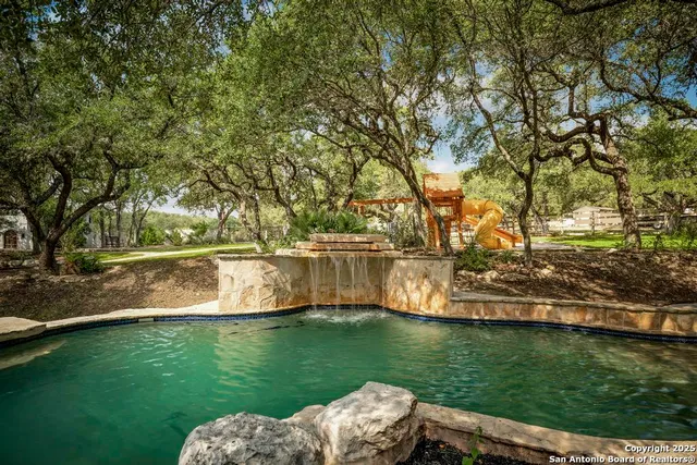 a view of a swimming pool with a patio
