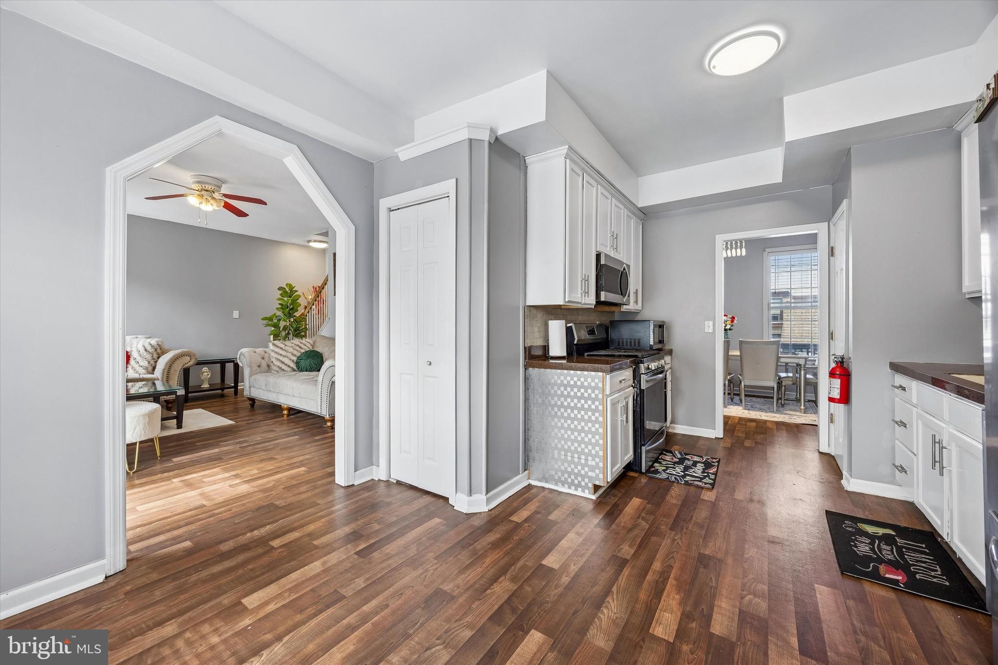 12 George Street Mount Ephraim, NJ 08059 - Photo 11 of 33 a kitchen with sink cabinets and wooden floor
