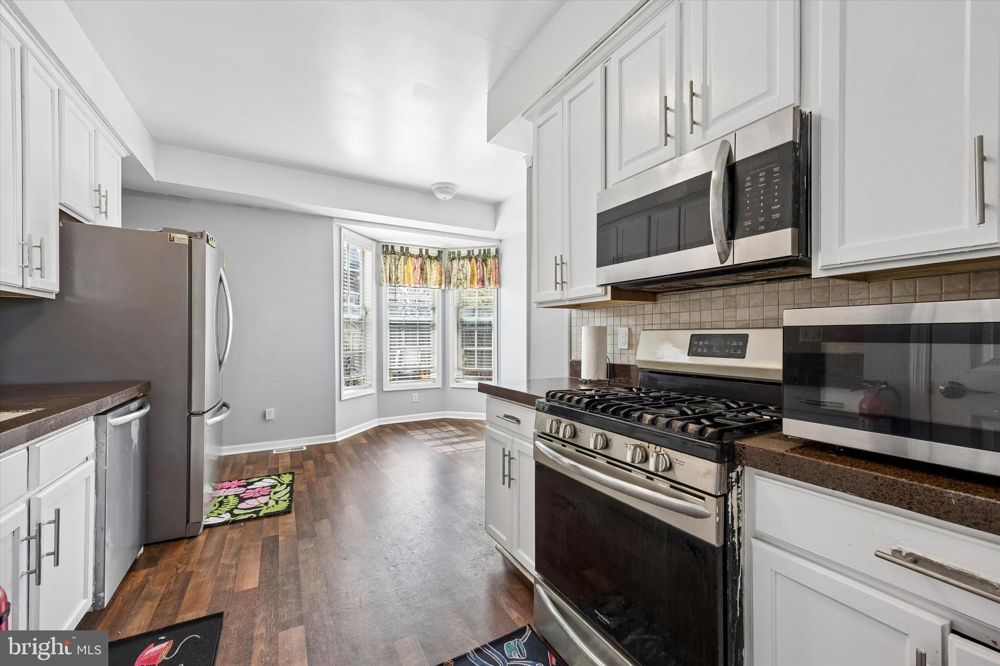 12 George Street Mount Ephraim, NJ 08059 - Photo 9 of 33 a kitchen with stainless steel appliances granite countertop a stove a microwave and a refrigerator