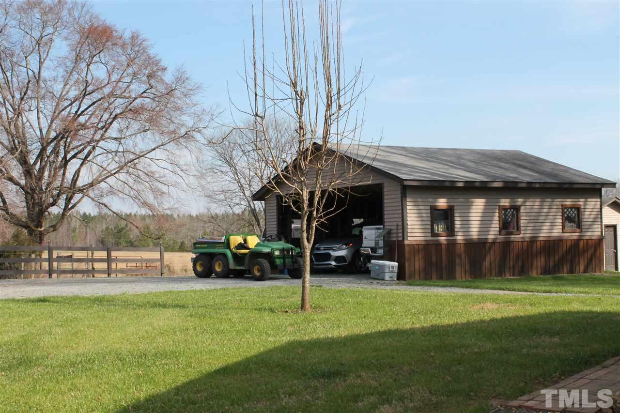 191 Sam Phillips Road Robbins, NC 27325 - Photo 14 of 25 a view of a house with a yard potted plants and a large tree