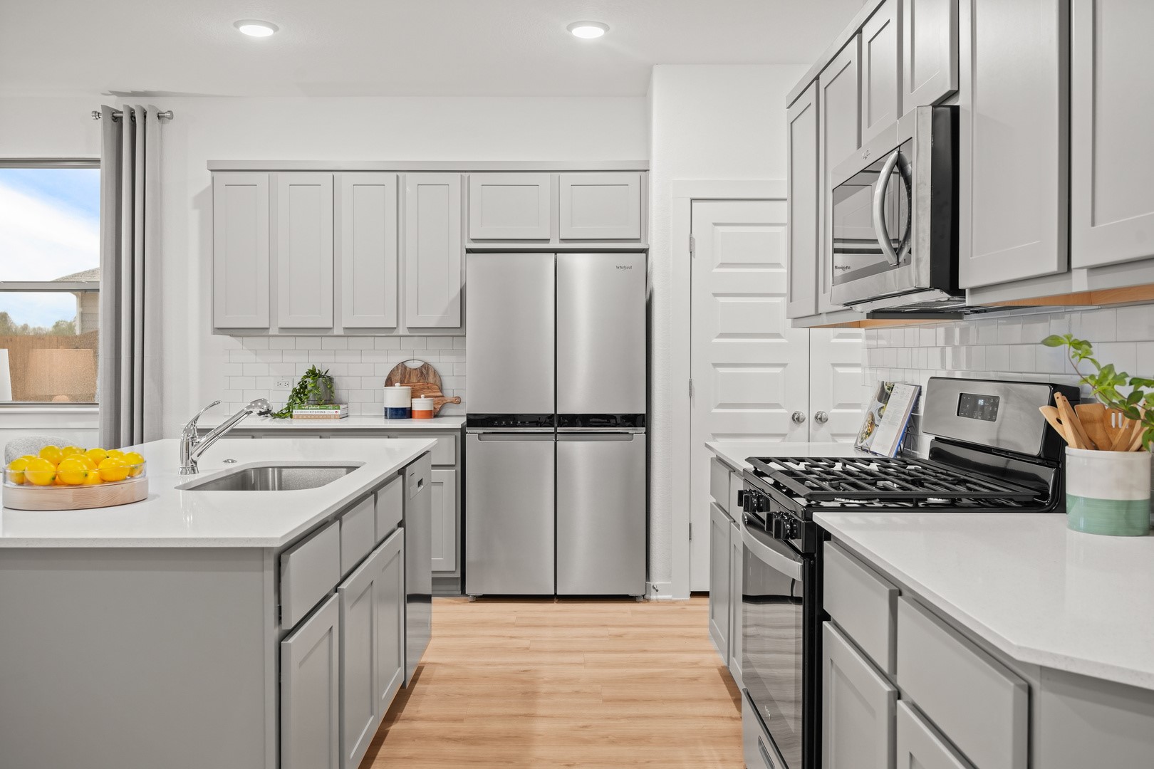 439 Lucky Avenue Elgin, TX 78621 - Photo 4 of 38 a kitchen with stainless steel appliances granite countertop a sink stove and refrigerator