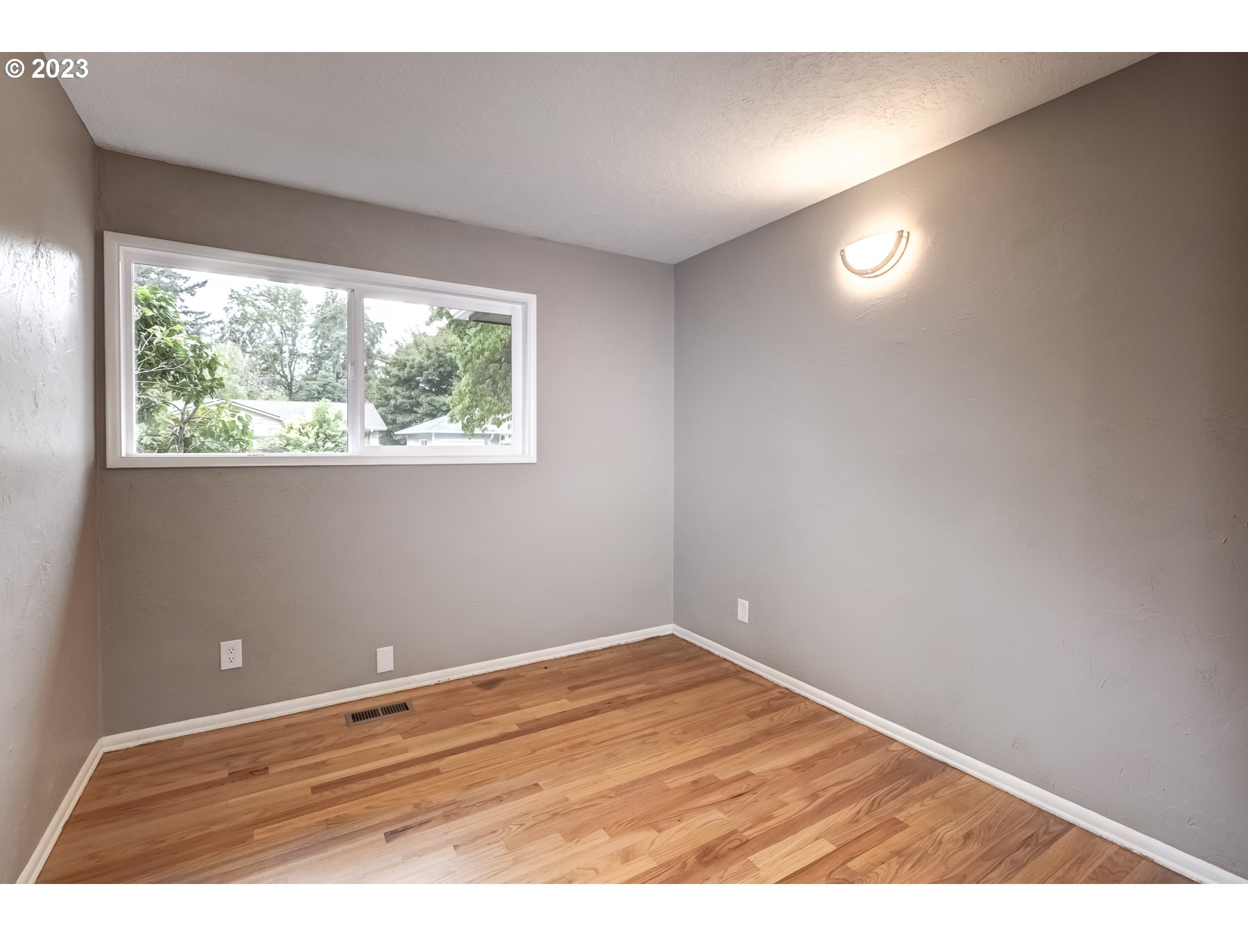 2540 Southeast 190th Avenue Gresham, OR 97030 - Photo 17 of 27 an empty room with wooden floor and windows
