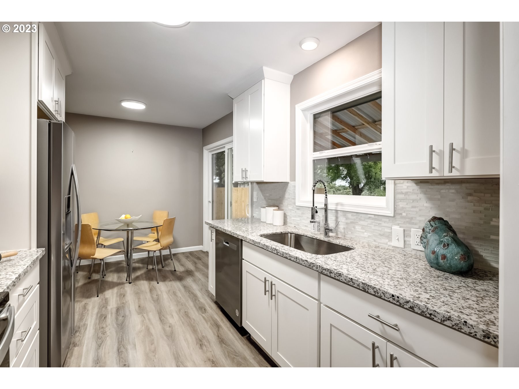 2540 Southeast 190th Avenue Gresham, OR 97030 - Photo 10 of 27 a kitchen with a sink a window and chairs