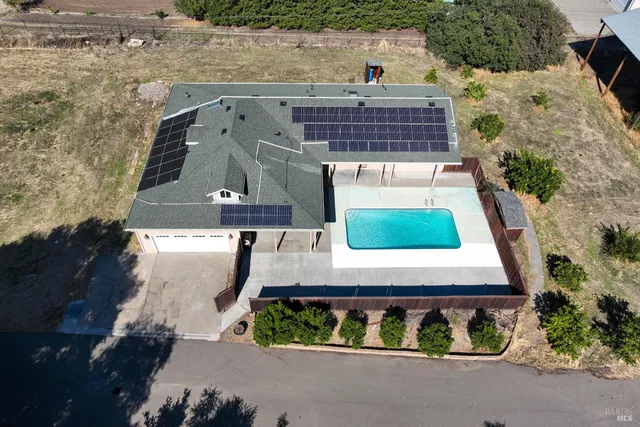 an aerial view of a house with a garden
