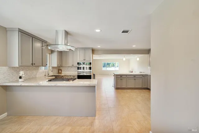 a kitchen with a stove a sink and a refrigerator