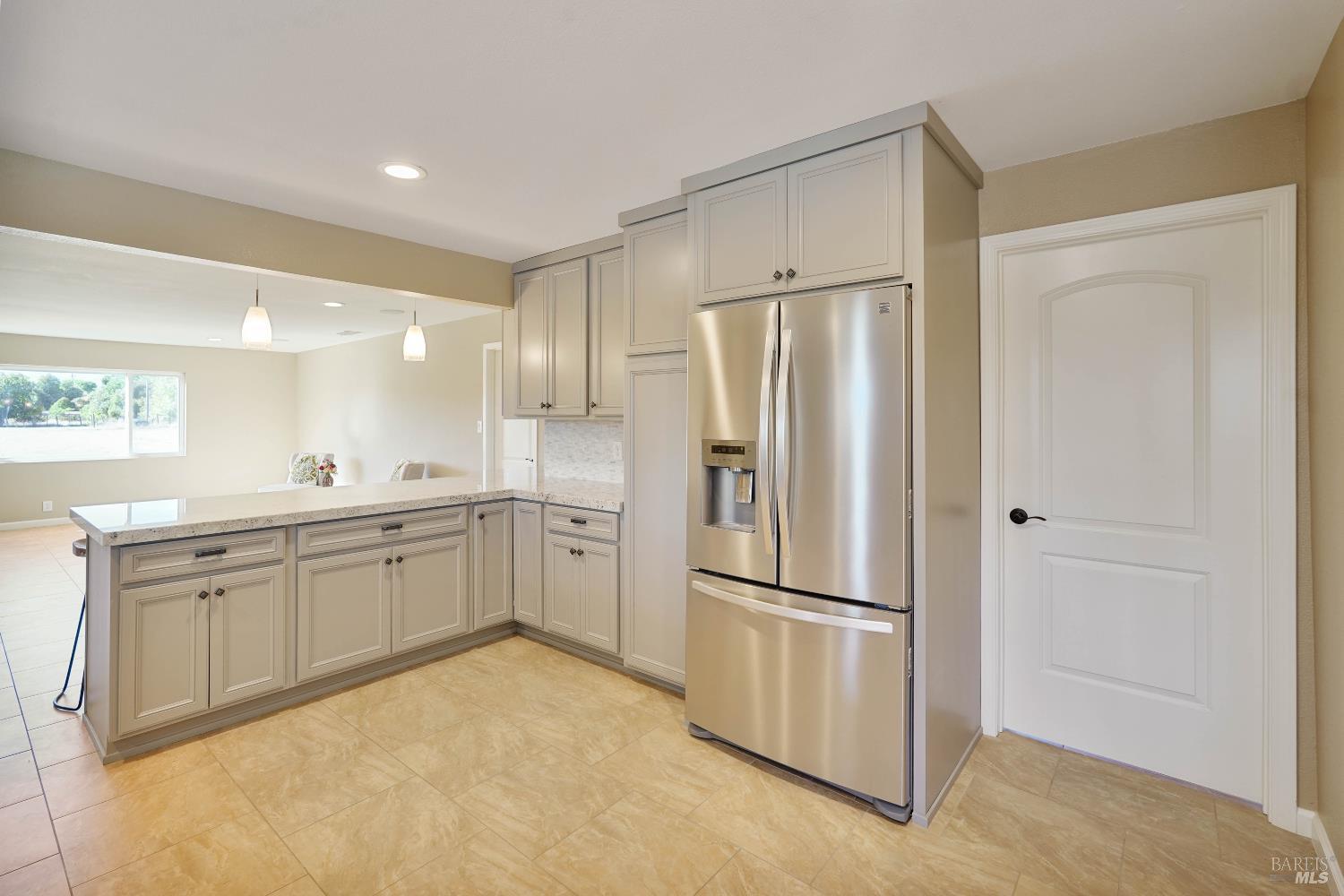 7208 Browns Valley Road Vacaville, CA 95688 - Photo 14 of 64 a kitchen with white cabinets and refrigerator
