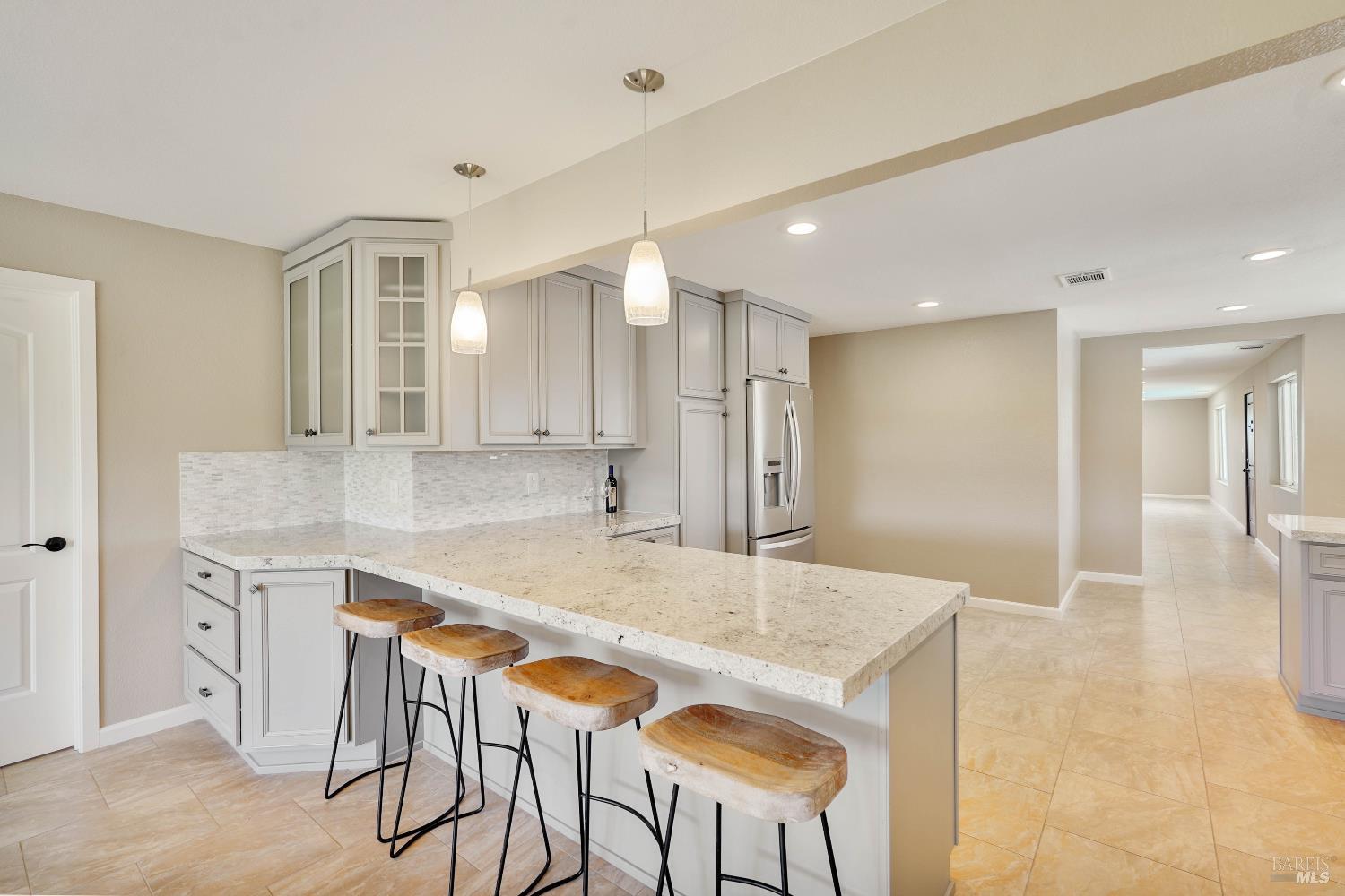 7208 Browns Valley Road Vacaville, CA 95688 - Photo 16 of 64 a kitchen with a sink cabinets and chairs