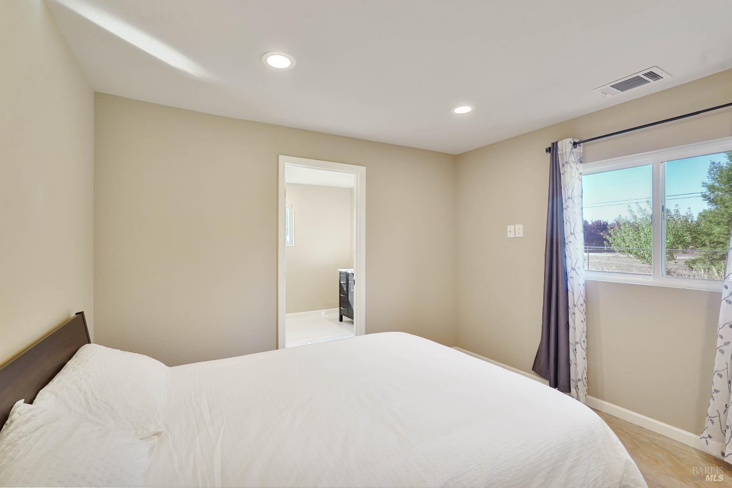 7208 Browns Valley Road Vacaville, CA 95688 - Photo 22 of 64 a bedroom with a large bed and a large window