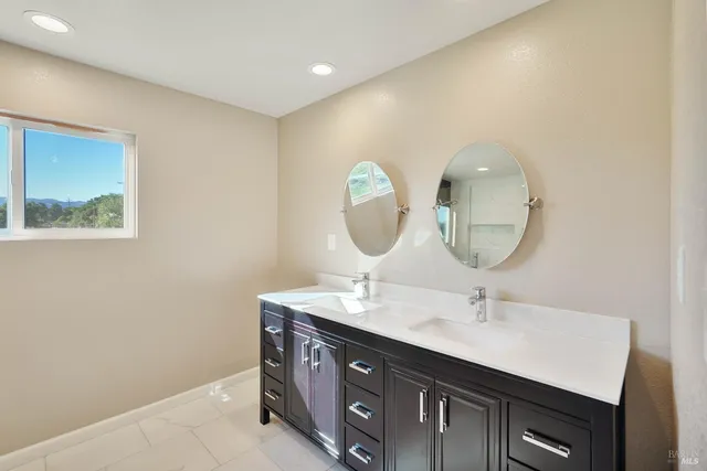 a spacious bedroom with two beds and a window