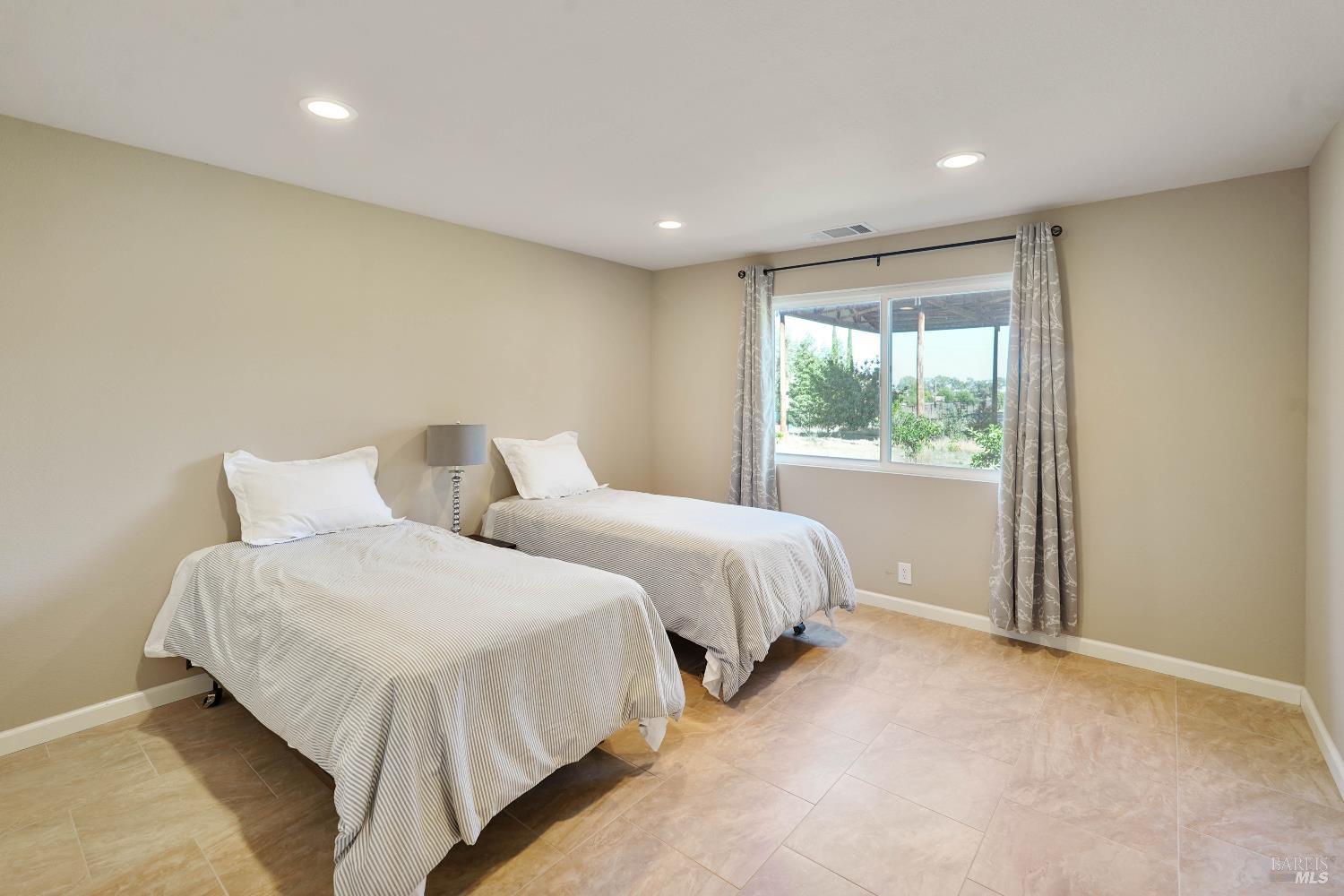 7208 Browns Valley Road Vacaville, CA 95688 - Photo 25 of 64 a spacious bedroom with two beds and a window