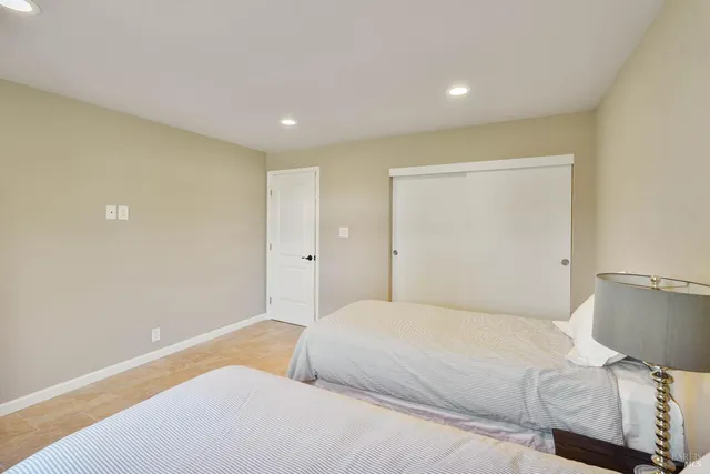 a bedroom with two beds and a window