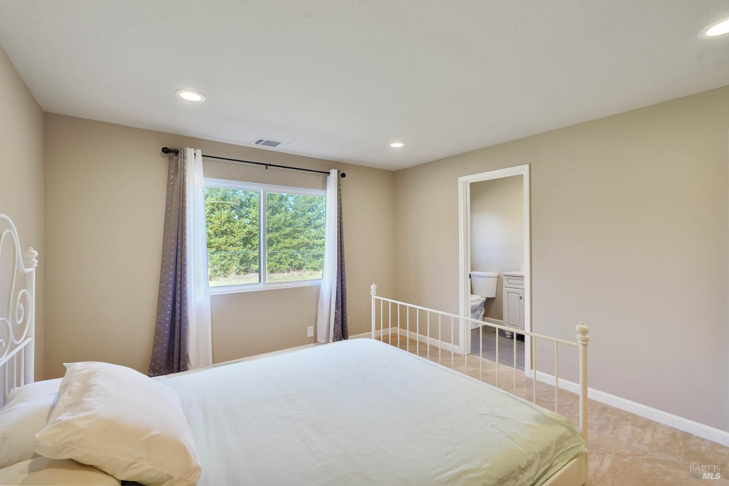 7208 Browns Valley Road Vacaville, CA 95688 - Photo 30 of 64 a bedroom with a bed and a window