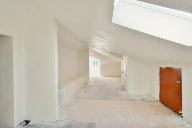 a view of a hallway with a livingroom with furniture