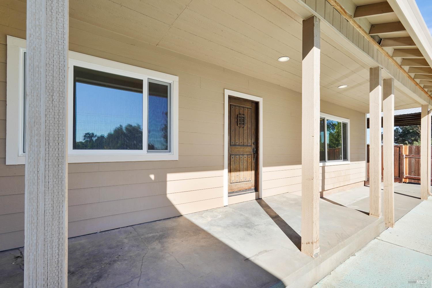 7208 Browns Valley Road Vacaville, CA 95688 - Photo 6 of 64 a view of a hallway with a large window and a rug