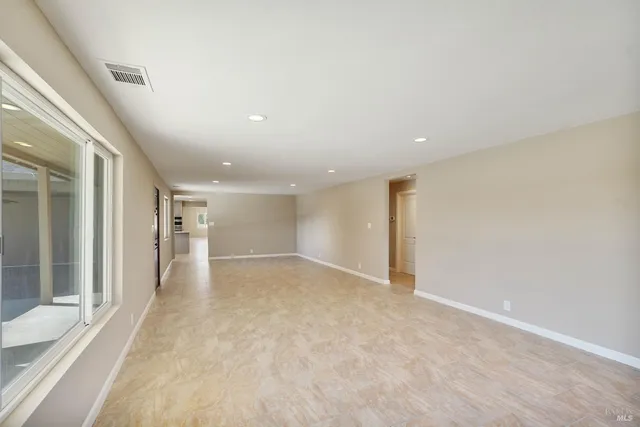 a kitchen with stainless steel appliances granite countertop a sink a stove a refrigerator and cabinets