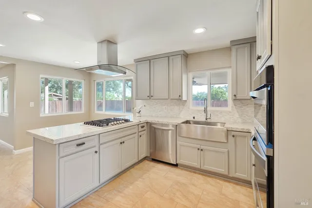 a kitchen with white cabinets and appliances