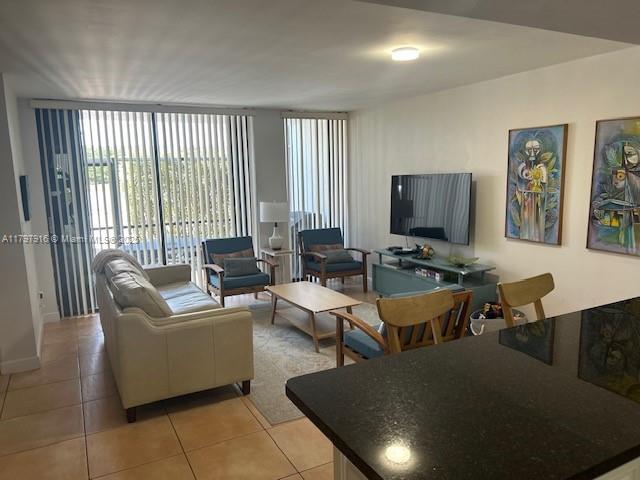 425 Grapetree Drive, Unit 209 Key Biscayne, FL 33149 - Photo 4 of 6 a living room with couches a coffee table and a flat screen tv