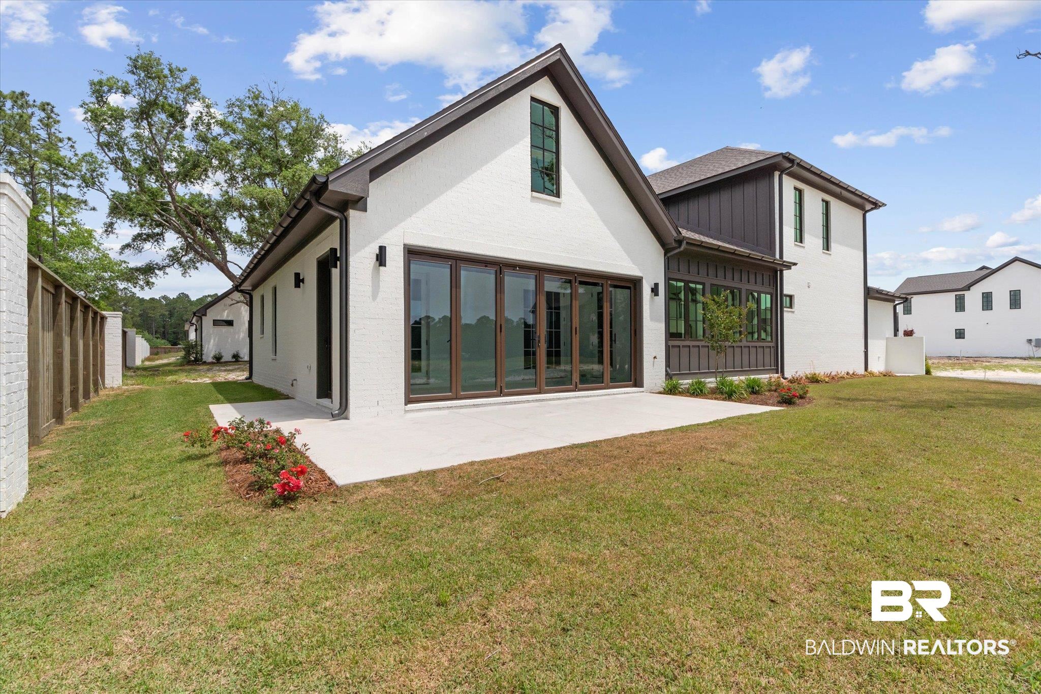 853 Inlet Circle Gulf Shores, AL 36542 - Photo 39 of 55 Back of house featuring a yard, a patio, fence, and brick siding