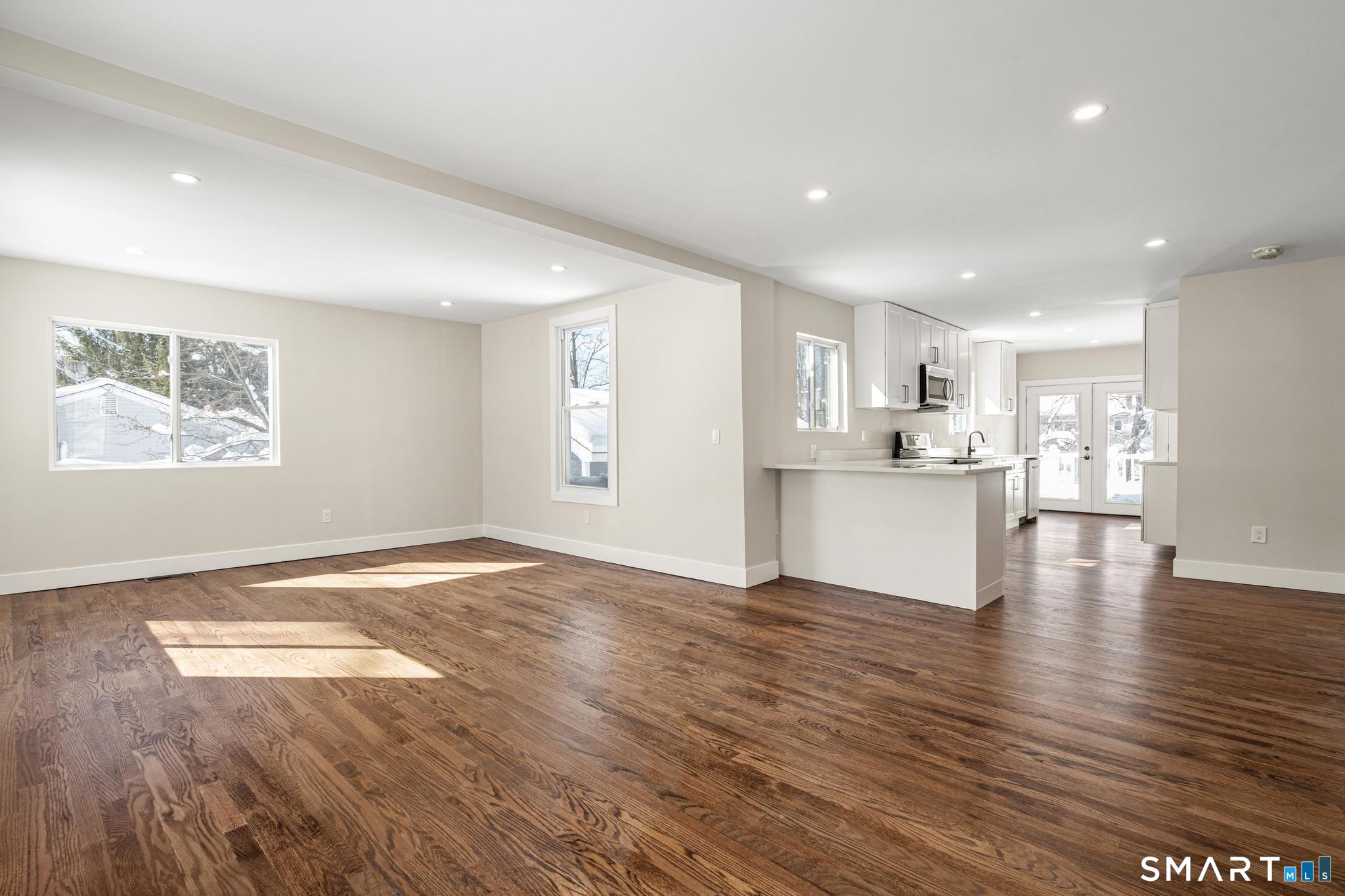 6 Juniper Ridge Drive Danbury, CT 06811 - Photo 5 of 36 a view of an empty room with wooden floor and a window