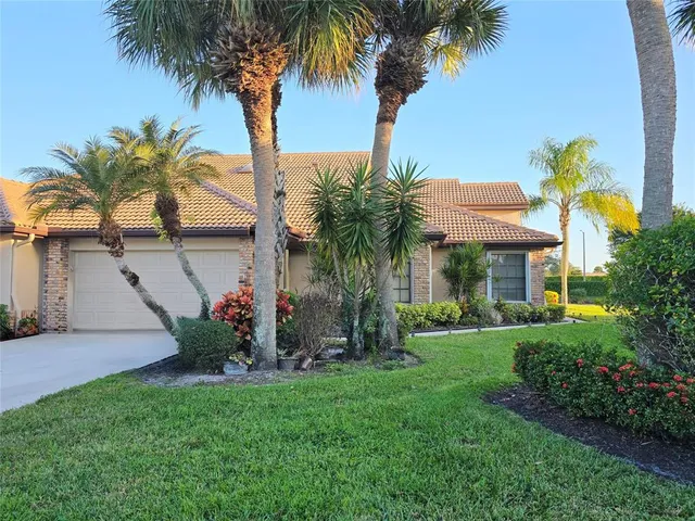 a view of a backyard with a garden and palm trees