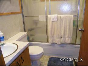310 Cold Spring Road Burnsville, NC 28714 - Photo 12 of 17 a bathroom with a sink a toilet and shower