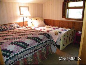 310 Cold Spring Road Burnsville, NC 28714 - Photo 14 of 17 a bedroom with a bed and a window