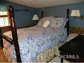 310 Cold Spring Road Burnsville, NC 28714 - Photo 16 of 17 a bedroom with a bed and window