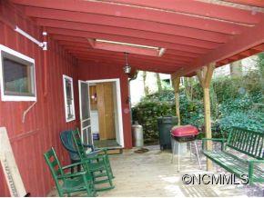 310 Cold Spring Road Burnsville, NC 28714 - Photo 3 of 17 a patio with table and chairs and potted plants