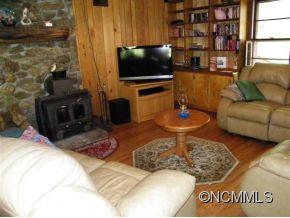 310 Cold Spring Road Burnsville, NC 28714 - Photo 9 of 17 a living room with furniture and a flat screen tv