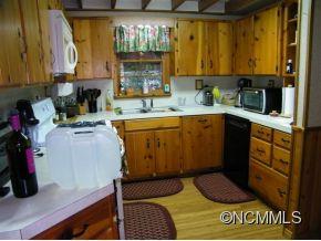 310 Cold Spring Road Burnsville, NC 28714 - Photo 10 of 17 a kitchen with a sink and cabinets