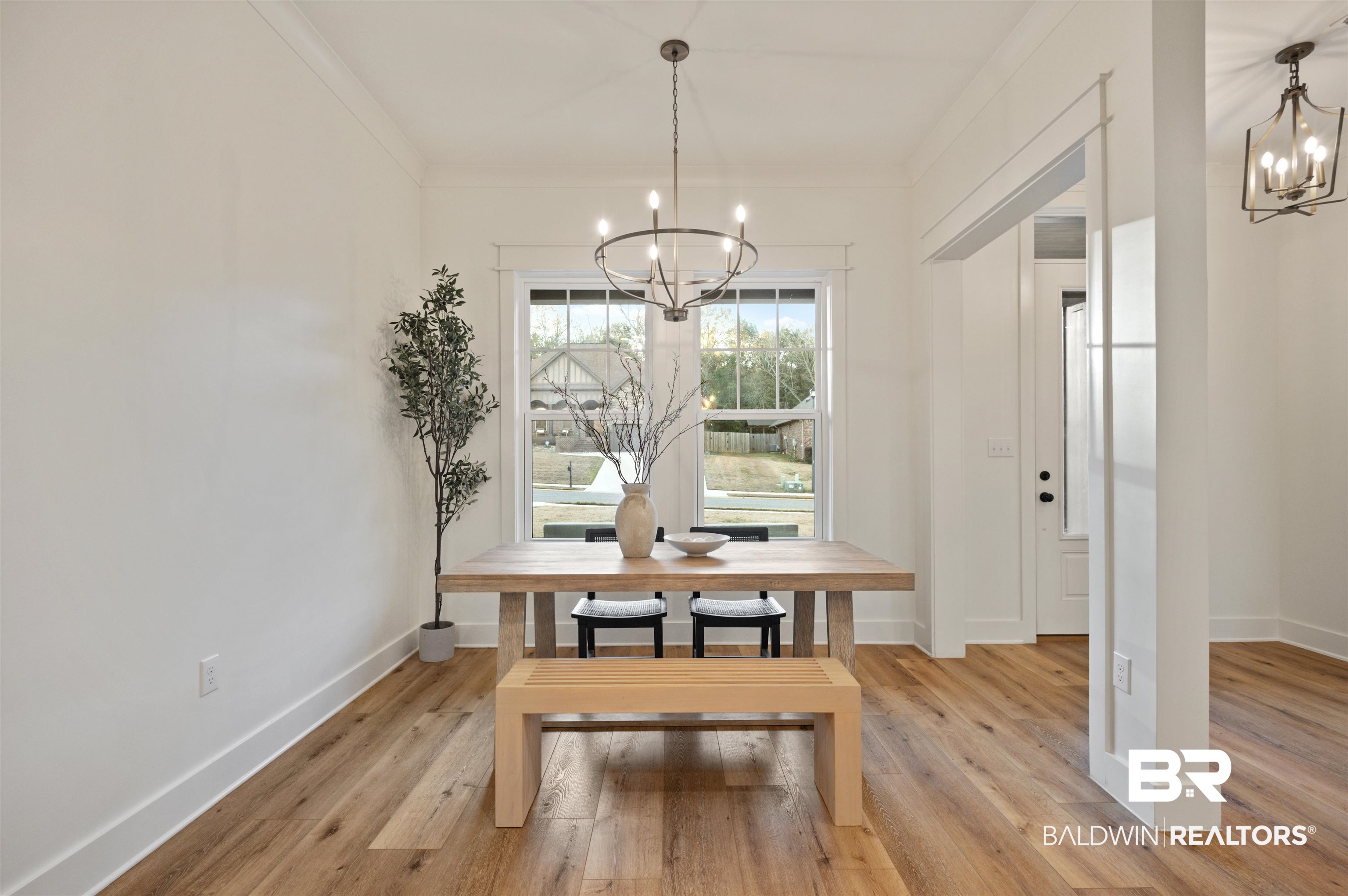 312 Pecan Ridge Boulevard Fairhope, AL 36532 - Photo 15 of 43 Dining room featuring crown molding, light hardwood / wood-style flooring, and a notable chandelier