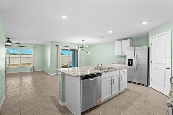 a kitchen with a sink and refrigerator