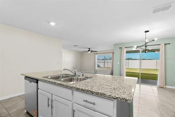a bathroom with a granite countertop sink and a large mirror