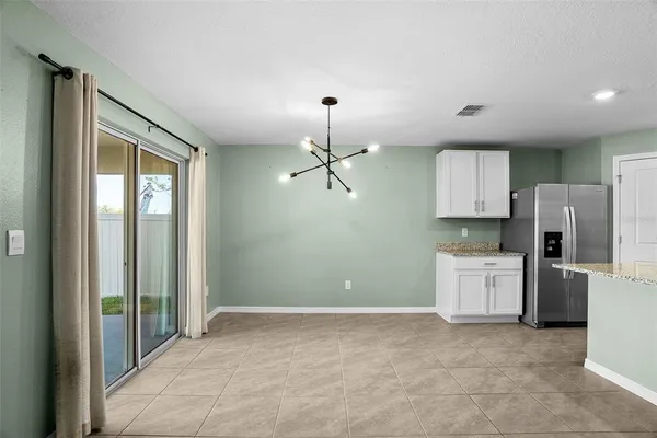 a kitchen with refrigerator and window