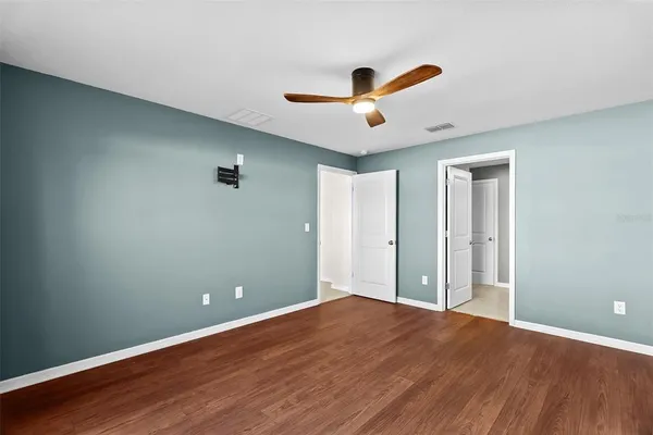 a view of an empty room with wooden floor