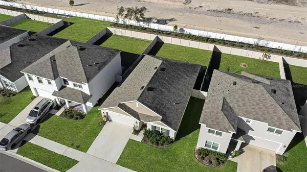 an aerial view of a house with a garden and deck