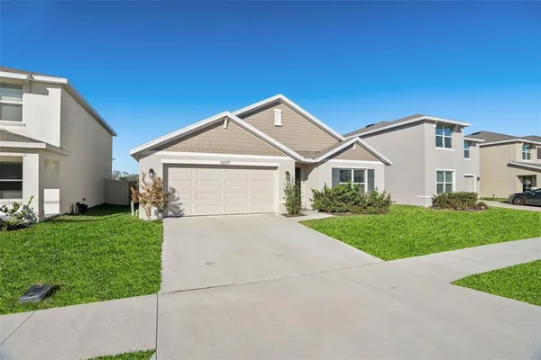 a front view of a house with a yard and garage