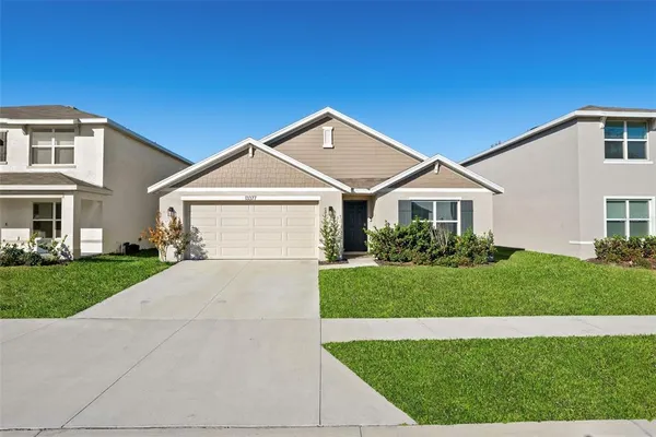 a front view of a house with a yard and garage