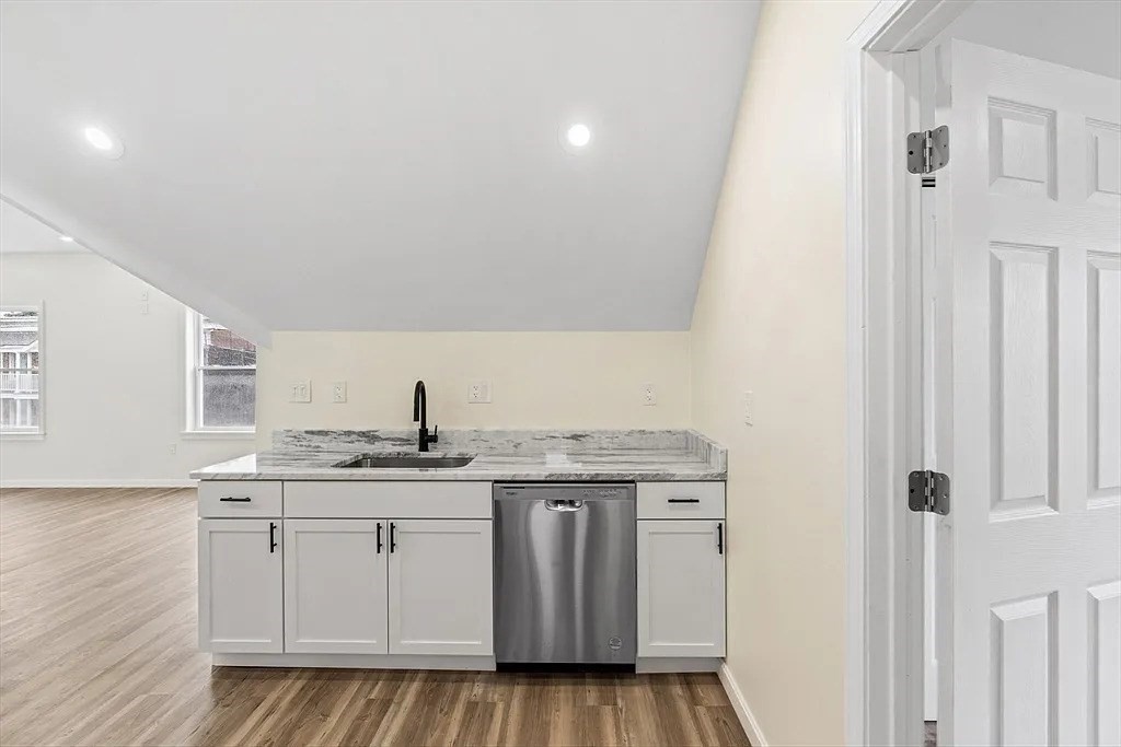 20 Graham Street, Unit 4 Gardner, MA 01440 - Photo 9 of 23 a kitchen with a sink a stove cabinets and a window