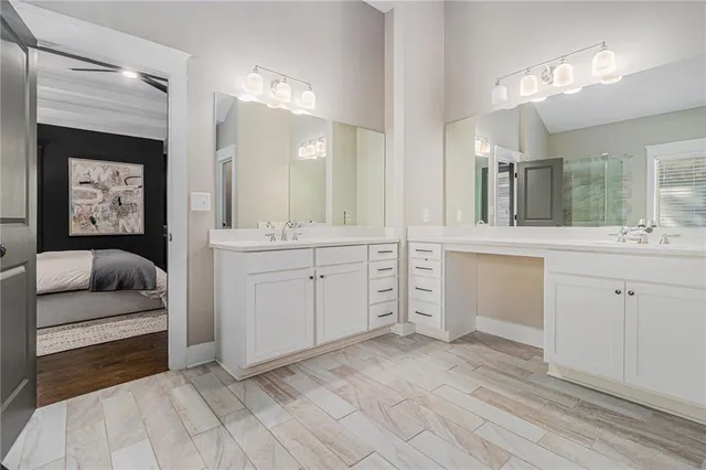 a spacious en suite bathroom with a double vanity sink and a mirror