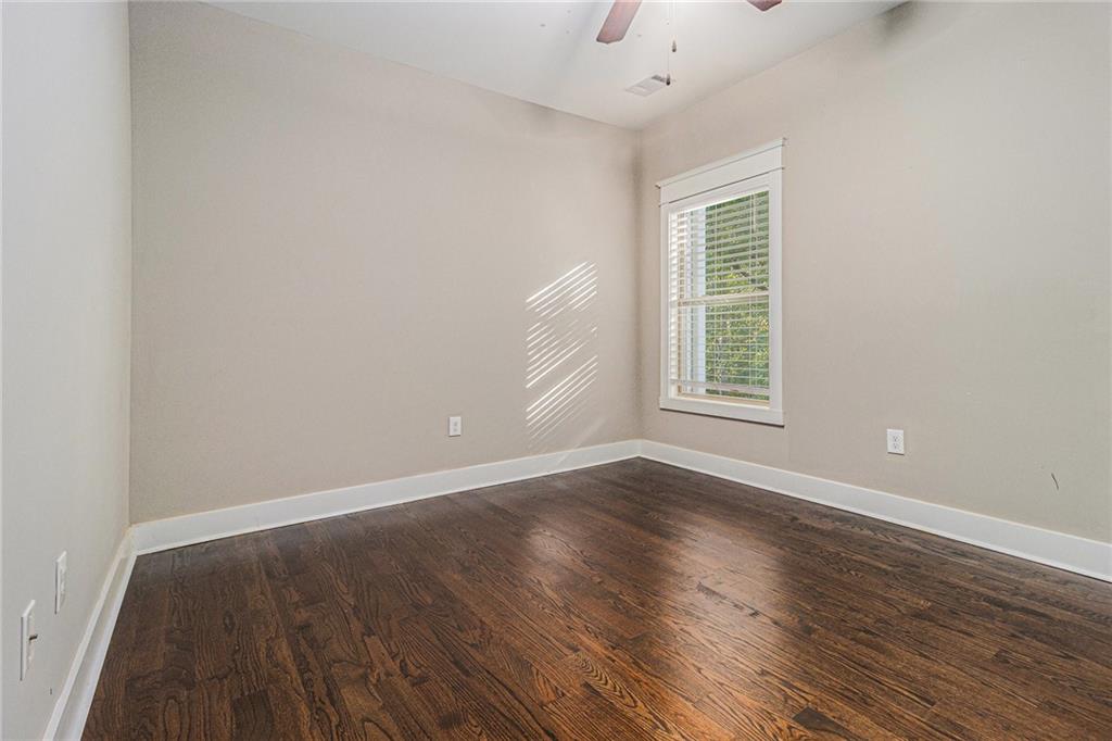 519 Holcomb Bridge Road Norcross, GA 30071 - Photo 19 of 31 wooden floor in an empty room with a window