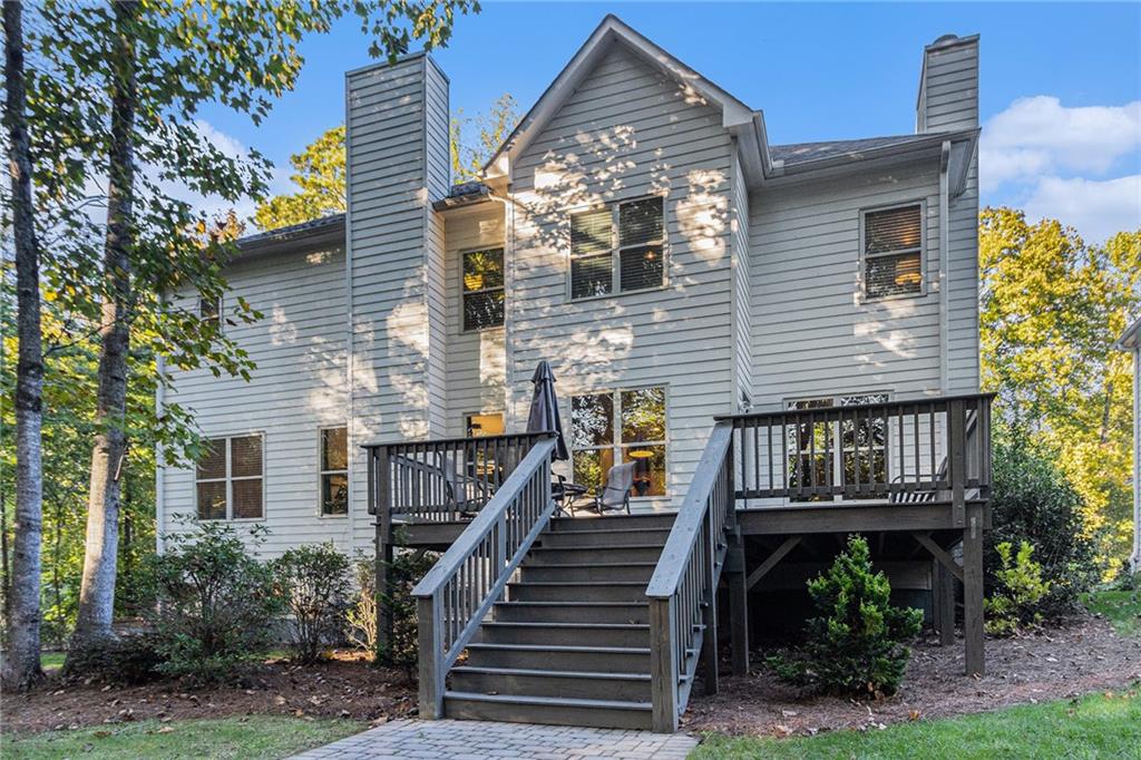 519 Holcomb Bridge Road Norcross, GA 30071 - Photo 30 of 31 a view of a house with wooden deck and a tree