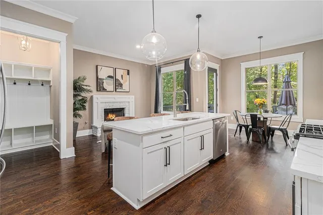 a spacious kitchen with stainless steel appliances granite countertop a stove and cabinets