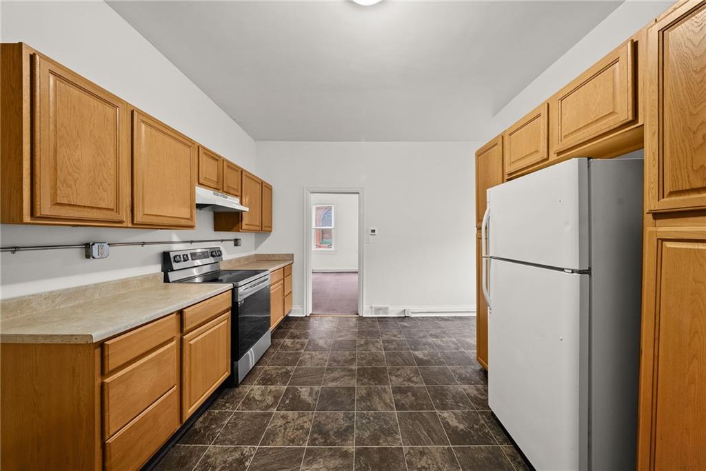 2016 Sidney Street Pittsburgh, PA 15203 - Photo 11 of 44 a kitchen with stainless steel appliances granite countertop a refrigerator a stove top oven a sink and dishwasher