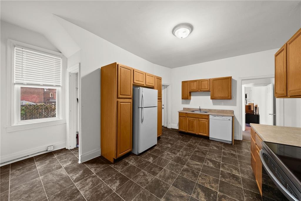 2016 Sidney Street Pittsburgh, PA 15203 - Photo 12 of 44 a kitchen with stainless steel appliances a refrigerator and a stove top oven