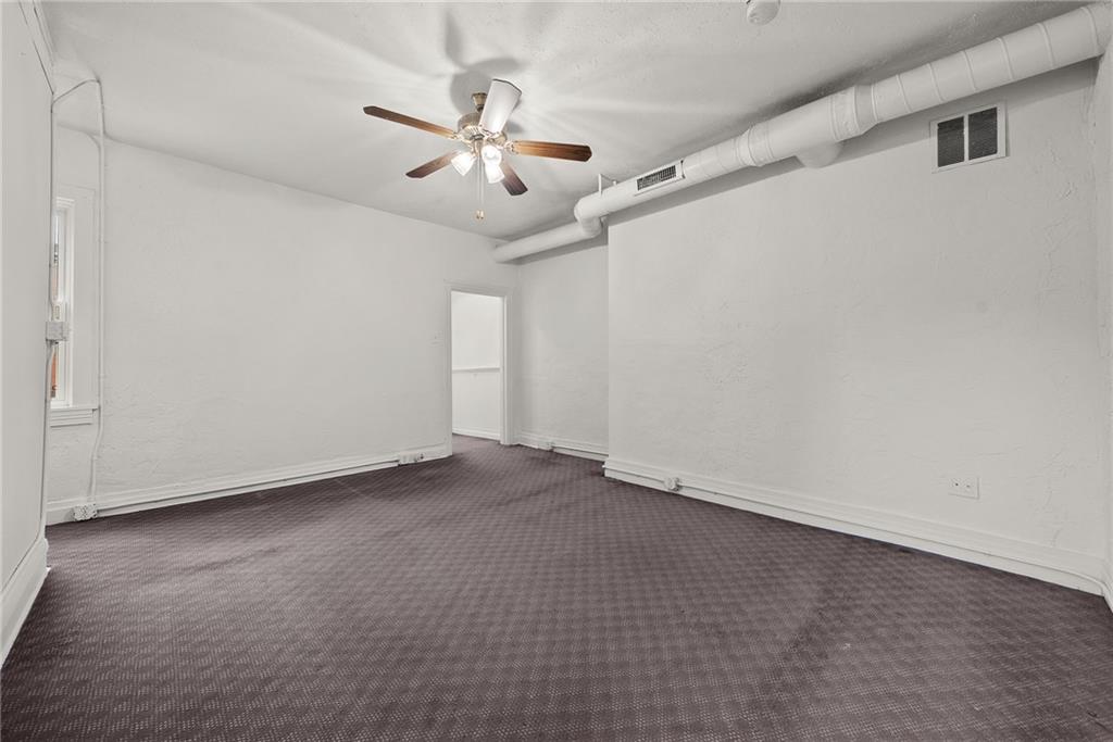 2016 Sidney Street Pittsburgh, PA 15203 - Photo 20 of 44 an empty room with chandelier fan and windows