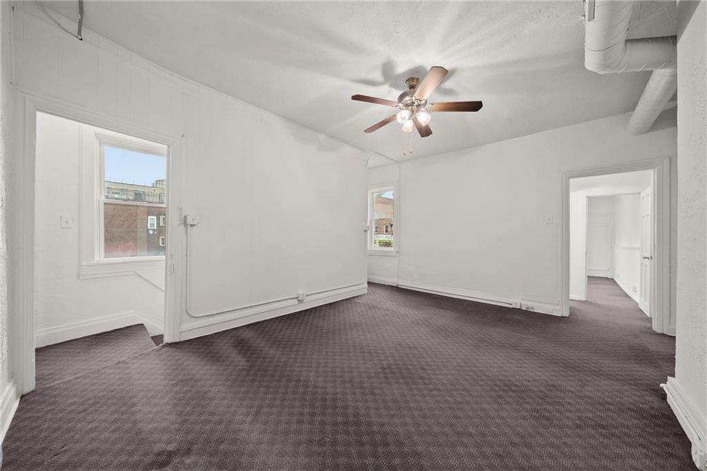 2016 Sidney Street Pittsburgh, PA 15203 - Photo 21 of 44 a view of an empty room with wooden floor and a ceiling fan