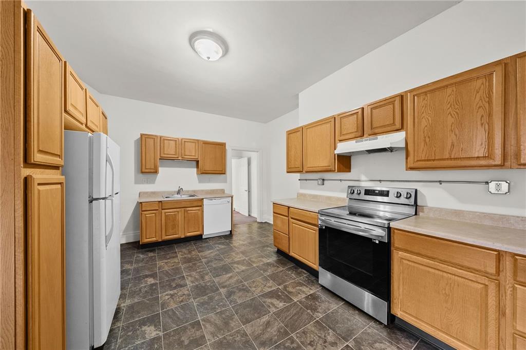 2016 Sidney Street Pittsburgh, PA 15203 - Photo 9 of 44 a kitchen with stainless steel appliances granite countertop a stove a sink dishwasher and a refrigerator