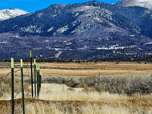 1350 St Spring Spring City, UT 84662 - Photo 11 of 29 Expansive undeveloped land with a distant mountain backdrop and a barbed wire fence